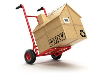 Delivery or moving houseconcept. Hand truck with cardboard box as home isolated on white. 3d