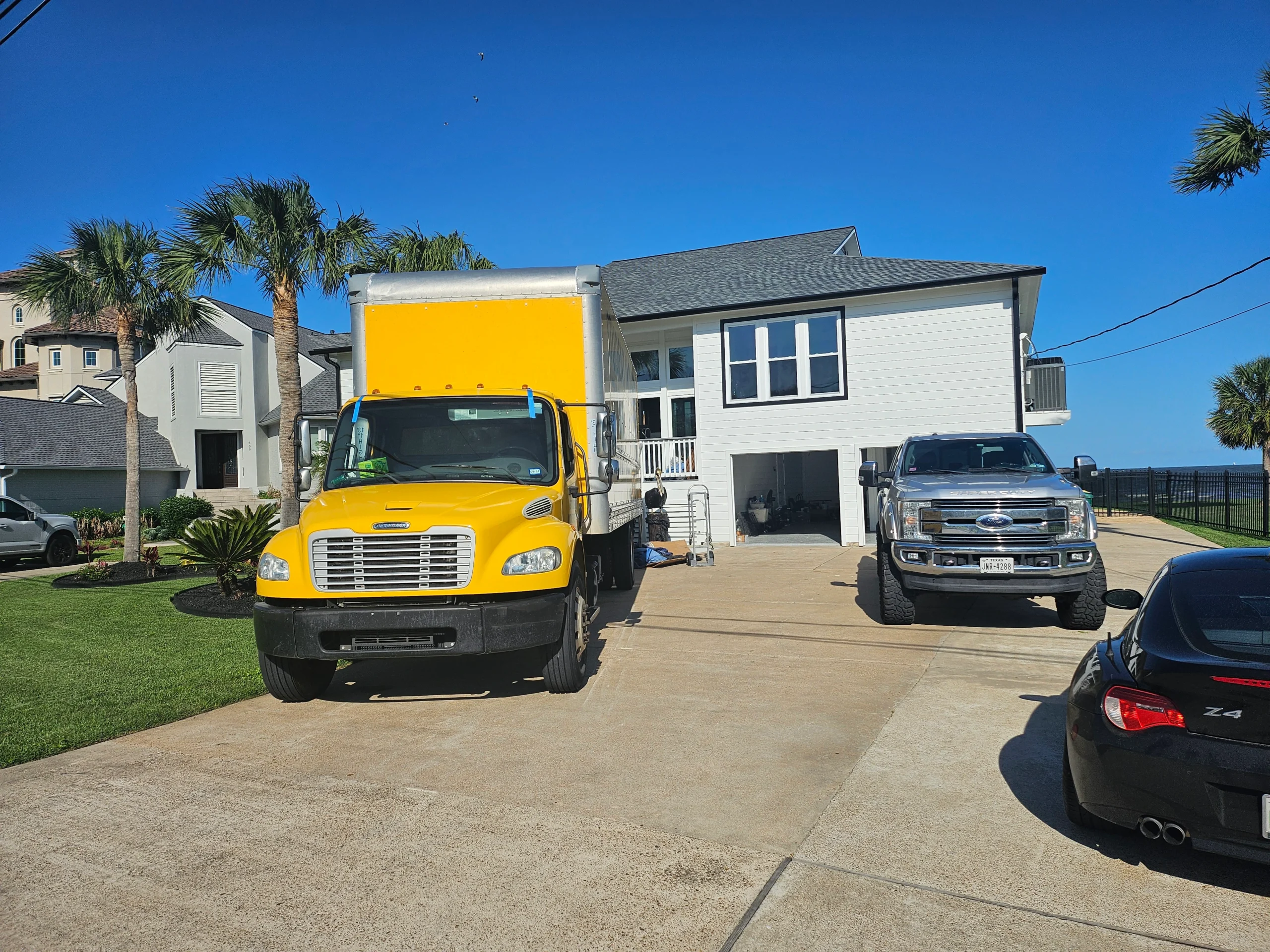 A moving truck parked in front of a home.